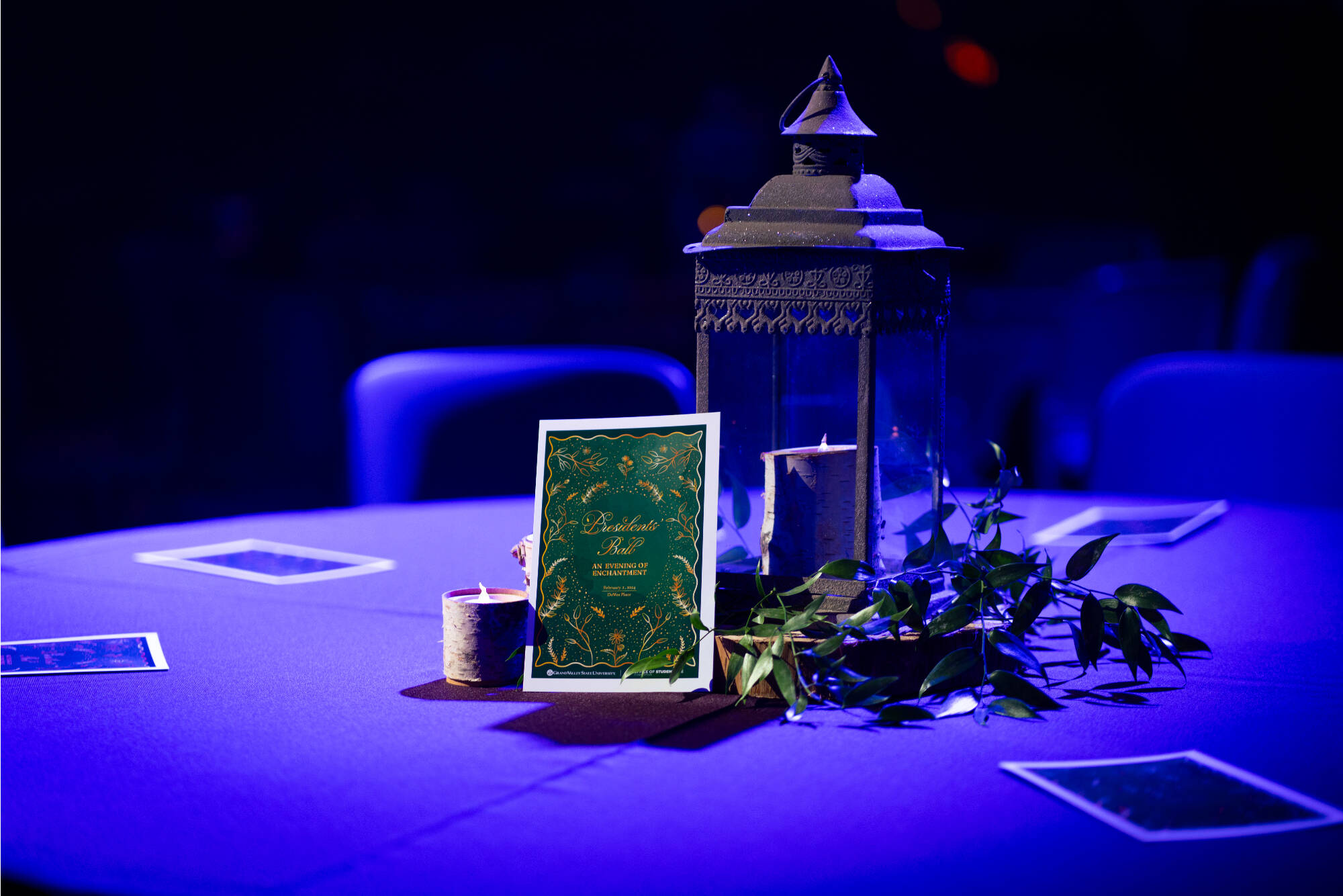 A green and gold Presidents' Ball program propped up on a table